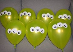 green balloons with googly eyes on them