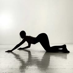 a woman laying on the floor with headphones in her ears and hands behind her back