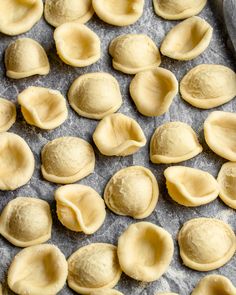 raw dumplings on a baking sheet ready to go into the oven