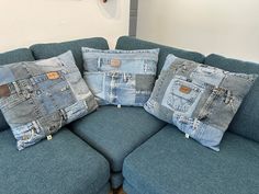 three pillows made out of jeans sitting on a couch