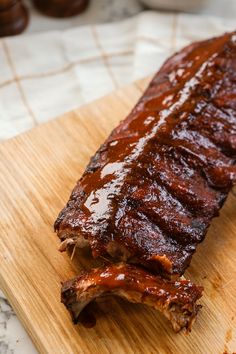 ribs on a cutting board covered in bbq sauce