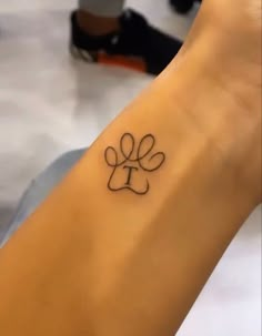 Paw print tattoo | Discreet tattoos, Tiny tattoos for girls, Simplistic tattoos Small Paw Print Tattoo With Initial, Dog Meaningful Tattoos, Tattoo For Multiple Dogs, 4 Inch Tattoos For Women, Shih Tzu Tattoo Minimalist, Simple Dog Tattoos, Tattoos Tiny, Pawprint Tattoo