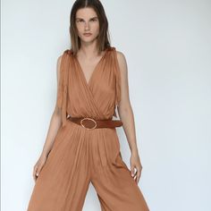 Brand New With Tags V-Neck Wrap Front Jumpsuit (Xs) With Wide Straps. Contrasting Belt With Metal Buckle. Elastic Waistband. Wide Leg. Spring Brown V-neck Jumpsuits And Rompers, Spring Brown V-neck Jumpsuit, Multicolor V-neck Jumpsuit With Tie Waist, Belted V-neck Jumpsuit, Solid V-neck Belted Jumpsuit, Jumpsuit With Belt, Zara Jumpsuit, Zara Pants, Neck Wrap