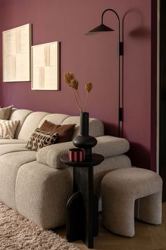 a living room with purple walls and furniture