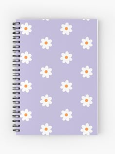 a purple notebook with white and orange flowers on it