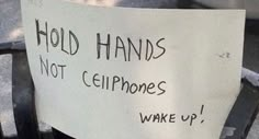 a sign that says hold hands not ciphones wake up on the back of a chair