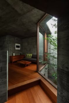 the interior of a house with wood flooring and large glass windows on one side