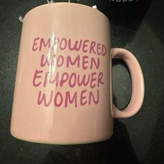 a pink coffee mug with the words emouered women empower women written on it