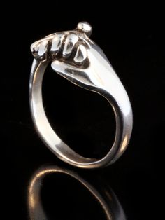 This solid sterling silver clasping Hand Ring is a classic and is beautifully executed. This design is a symbol of love, friendship, support and solidarity. We have many ring sizes immediately available. We will contact you to let you know if we have your chosen ring size in stock or when to expect shipment. All Marty Magic Jewelry is packaged in a beautiful box embossed with the gold foil Marty Magic dragon logo. Perfect for any occasion! Designed in California by Marty Magic. Made in the U.S.A Classic Sterling Silver Hand Cast Rings, Classic Hand Cast Sterling Silver Rings, Sterling Silver Rings With Polished Finish For Gift, Sterling Silver Promise Jewelry, Symbolic Promise Jewelry With Polished Finish, Symbolic Nickel-free Promise Rings, Symbolic Sterling Silver Rings With Polished Finish, Sterling Silver Round Band For Anniversary, Nickel-free White Gold Promise Jewelry