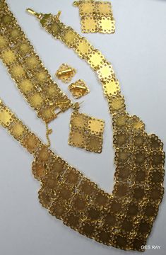 "Fabulous Etruscan Style gold plated filigree panel jewelry set/ parure: necklace, bracelet, clip on earrings and pierced earrings. The bracelet is 7 1/4\"\" long and 1 1/4\" wide and it has a flip over clasp. It has a 2\" long secure chain with the spring clasp The necklace , clip on earrings and the bracelet are marked \" D'Orlan\". The regular earrings are not marked. The inside necklace measurement is 17 inches and 5/8\" wide at the widest point.The middle ornamental piece is 6\" long and 3\ Festive Filigree Metal Jewelry, Festive Metal Filigree Jewelry, Filigree Metal Jewelry For Parties, Metal Filigree Jewelry For Parties, Vintage Gold Plated Jewelry For Party, Elegant Gold-tone Jewelry With Filigree, Elegant Gold-tone Filigree Jewelry, Yellow Gold Filigree Metal Jewelry, Yellow Gold Filigree Jewelry