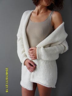 "Luxury, amazingly soft, oversized alpaca knit sweater cardigan . The pattern has relaxed fit with dropped shoulders. Color is off white. For colors available in pearl /light grey, black/charcoal, brown, crem/wheat, blue /green, burgundy, violet and pink click here https://www.etsy.com/ca/listing/187868895/alpaca-chunky-knit-woman-cardigan?ref=related-1 A new and exciting \"blow yarn\" made from soft 72% Baby Alpaca and cozy Merino wool. Its construction is unique, based on the newest yarn techn Handmade White Knit Sweater, White Chunky Knit Sweater Coat For Winter, Oversized White Knitted Outerwear, White Chunky Knit Cardigan For Winter, Cozy Handmade White Cardigan, Handmade White Sweater For Winter, White Hand Knitted Outerwear, Handmade White Sweater, White Hand Knitted Knit Outerwear