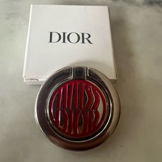 a red dior logo on a white box