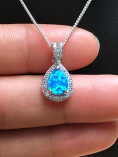 Sterling Silver White Blue Opal and CZ Necklace Bridal/Wedding Opal Necklace Metal: All Components Are Made From .925 Sterling Silver Stone: Lab created Opal and Cubic Zirconia Measurement: pendant height is 20mm including bail Choose Chain Length Please feel free to Convo me with any questions before purchasing. Please view policy before purchasing Other Opal Necklaces can be found here https://www.etsy.com/shop/LinksAndStones?ref=ss_profile&section_id=24284450 Thank You For Visiting My Sho Opal Teardrop Pendant Necklace With Gemstone, Blue Opal Gemstone Necklaces, Pear-shaped Opal Gemstone Necklace, Handmade Blue Opal Necklaces, Pear-shaped Opal Necklaces For Gifts, October Birthstone Jewelry, Fire Opal Necklace, Cz Necklace, Opal Necklace