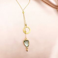 Our ballet collection is designed to be both modern and feminine. Pairing a beautiful circle accent with green amethyst gemstones (also known as prasiolite) in the graceful, signature design of our ballet necklace. 14k gold plated over fine Italian silver. Necklace chain is adjustable up to 2”.Total chain length with drop is 19".Handmade. Elegant Faceted May Birthstone Necklaces, Delicate Gold Necklaces With Gemstone Accents, Delicate Gold Necklace With Gemstone Accents, Gold Drop Necklace With Gemstone Accents, Chic Gold Necklace With Gemstone, Gold Jewelry With Green Amethyst Birthstone, Modern Gold Necklaces With Gemstone Accents, Elegant Gold Plated Necklaces With Gemstone Accents, Chic Gold Necklaces With Gemstone