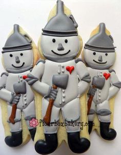 three decorated cookies in the shape of soldiers