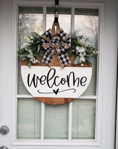 a welcome sign hanging on the front door