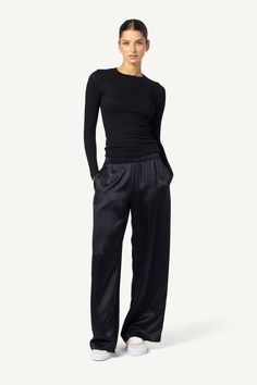 As if a wide-leg pant made of the smoothest silk wasn't enough, Brynn has pockets, too. A perfect addition to any wardrobe. Crafted from 100% pure silk, this wide-leg pant is both stylish and practical. The sewn-in waistband provides a comfortable and flattering fit, while the pockets add a touch of functionality. Designed for the modern woman, this pant is perfect for the office or a night out on the town. With its effortless elegance, the Brynn Silk Pant will quickly become a go-to in your clo Sleek Silk Wide Leg Pants, Elegant Black Wide Leg Viscose Pants, Elegant Black Viscose Wide Leg Pants, Sleek Wide-leg Silk Pants, Sleek Silk Wide-leg Pants, Black Wide Leg Viscose Pants, Black Viscose Wide Leg Pants, Black Full Length Viscose Bottoms, Silk Wide Leg Pants With Elastic Waistband For Work