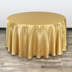 a round table with a gold cloth on it