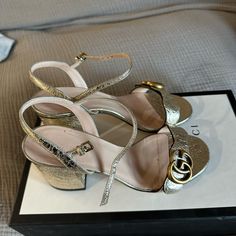 Gucci Metallic Gold Sandals Gucci Luxury Sandals With Buckle Closure, Luxury Gucci Sandals With Buckle Closure, Luxury Gucci Sandals With Heel Strap, Gucci Block Heel Evening Sandals, Gucci Evening Sandals With Block Heel, Gucci Block Heel Sandals For Evening, Chic Gucci Sandals With Block Heel, Gucci Formal Block Heel Sandals, Luxury Gold Low Heel Sandals