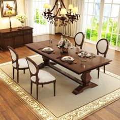 a dining room table with chairs and a chandelier in the middle of it