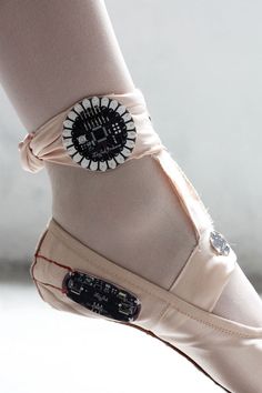 a woman's shoe with a button on it