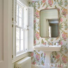 a bathroom with a sink, mirror and radiator next to a window in the wall