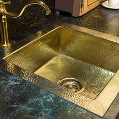 a kitchen sink that is gold in color