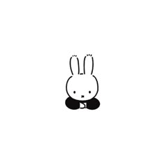 a black and white drawing of a rabbit sitting on the ground with its eyes closed