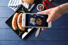 a person taking a photo of food on their phone