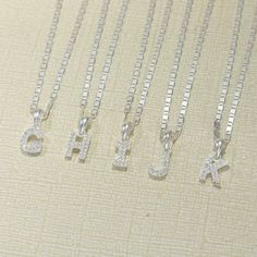 "Sterling silver alphabet letter pendants, available in all 26 letters.Simple, elegant design, perfect for everyday wear. Great gift for a loved one or a special treat for yourself. Add a personal touch to your jewelry with these stunning sterling silver alphabet letter pendants. The simple and elegant design makes these pendants perfect for everyday wear, and they can be layered with other necklaces for a trendy look. Whether you're looking for a gift for a loved one or a special treat for your Silver Initial Pendant Necklace With Letter Beads, Silver Initial Necklace With Letter Beads, Silver Letter Initial Necklace For Everyday, Silver Letter Initial Necklace, Silver Sterling Initial Letter Necklace, Silver Necklaces With Letter Print For Mother's Day, Silver Letter Print Necklace For Mother's Day, Silver Sterling Silver Necklace With Letter Beads, Silver Necklace With Letter Print For Mother's Day