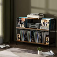 an entertainment center with cd's, cds and other musical equipment on top of it