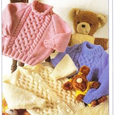 several knitted sweaters and teddy bears on a chair