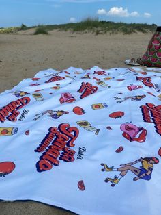 there is a blanket on the beach that says summer