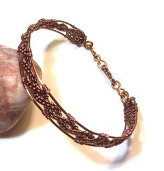 a close up of a bracelet on a rock