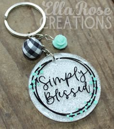 a close up of a keychain on a table with the words simply bliss