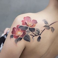 a woman with a flower tattoo on her shoulder