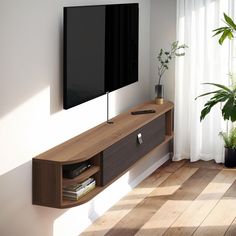 a flat screen tv mounted to the side of a wooden entertainment center in a living room