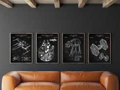 three black and white drawings hang on the wall above a leather couch in a modern living room