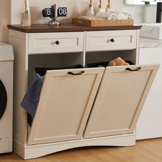 PRICES MAY VARY. High Quality: 39.76"L x 13.58"W x 38.58"H trash can cabinet (trash can not included). Made of MDF, the tilt out trash cabinet which fits up to 2 x 13 gallon trash can. You can put microwave, coffee maker or anything you want on the tabletop. Multifunctional Design: The trash cabinet is not only a practical kitchen trash can but it can also be used as the laundry basket or recycling bin, as well as a pet food bin. The drawers provide the convenient storage space for small sundries. Modern Trash Cabinet: Tilt out trash cabinet is simple and practical. It can be easily incorporated into a variety of decorating styles. It will be perfect for dressing up your kitchen, home, apartment, dorm room, etc. It also can be used as a kitchen island or suitable to store dog food, cat foo Trash Can Storage Kitchen Pull Out, Kitchen Trash Can Cabinet The Home Depot, Trash Can Storage Kitchen Farmhouse, Cabinet With Trash, Double Garbage Cabinet, Laundry Cabinet Tilt, Trash Cabinet Hardware, Recycle Garbage Storage, Ikea Recycle Bin Hack