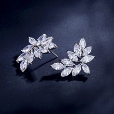 A delightfully unique pair of bridal earrings with an incredible sparkle! Adorned with flawlessly faceted cubic zirconia that capture the light in a dazzling array of sparkles, the earrings are rhodium plated for a bright finish which enhances the intricate detailing and conveys a modern take on old elegance. The earrings are 1" (approx. 2.5cm) in length and come with sturdy backs. Available in Silver, Rose Gold and Yellow Gold finishes. To make your choice select your preferred finish from the Glamorous Diamond White Cubic Zirconia Earrings, Dazzling Diamond White Crystal Earrings With Sparkling Stones, Wedding Earrings With Brilliant Cut Cubic Zirconia, Glamorous Cubic Zirconia Flower Earrings For Gift, Dazzling Diamond White Earrings With Sparkling Stones, Glamorous Flower Earrings With Cubic Zirconia For Gift, Sparkling Cubic Zirconia Crystal Earrings, Anniversary Crystal Earrings With Sparkling Details, Formal Cubic Zirconia Flower Drop Earrings