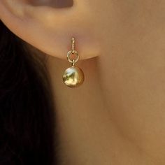 Delicate 14k gold earrings, classy and timeless, handmade by Sigal Gerson Gold Sphere Single Earring, Gold Spherical Single Earring, 14k Yellow Gold Huggie Dangle Earrings, Recycled Yellow Gold Huggie Earrings, Yellow Gold Huggie Earrings In Recycled Gold, Polished Yellow Gold Earrings In Recycled Gold, Yellow Gold Earrings With Polished Finish From Recycled Gold, 14k Gold Dangle Huggie Earrings, Polished Yellow Gold Earrings Of Recycled Gold