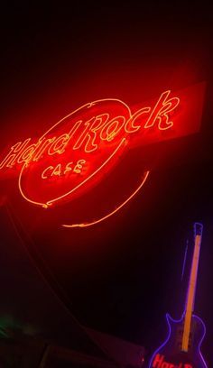 the neon sign for hard rock cafe is lit up