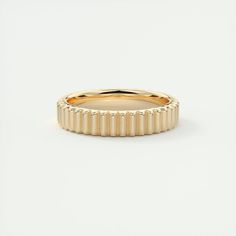 an 18k gold band ring with spikes on the outside and inside, set against a plain white background