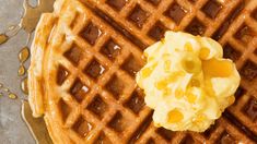 a waffle topped with butter and syrup