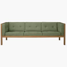 a green couch sitting on top of a wooden frame