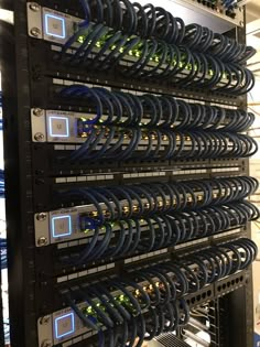 several servers stacked on top of each other in a server room with many wires attached to them