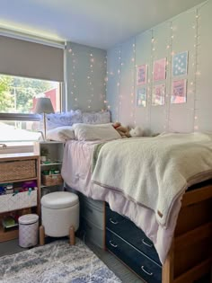 a bed room with a neatly made bed next to a window and a rug on the floor