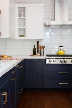 a kitchen with blue cabinets and white counter tops