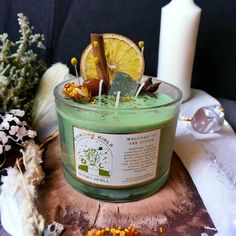 a green candle sitting on top of a wooden table