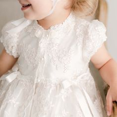 Handmade in the USA This girls Baptism gown is so gorgeous and so detailed, it's not a stretch to say that it is truly a work of art. The lace overlay on this baptism gown is both stunning and special, made of embroidered netting with a rich floral design featuring embroidered flowers in a pretty shade of ivory with champagne cording, adding depth and richness. Trimmed in ivory Venice edging and long ivory silk ribbon bows flowing down the skirt. Includes the matching sheer lace bonnet. This bea Elegant Baptism Dress With Lace Trim And Organza, Ceremony Dress With Intricate Embroidery And Fitted Bodice, Lace Ball Gown With Intricate Embroidery, Baptism Ball Gown With Lace Bodice, Fitted First Communion Dress With Lace Sleeves, Elegant Tulle Baptism Dress For Ceremony, Fitted Tulle Gown For Confirmation, Lace Dress With Fitted Bodice For First Communion, Fitted Lace Bodice Dress For First Communion